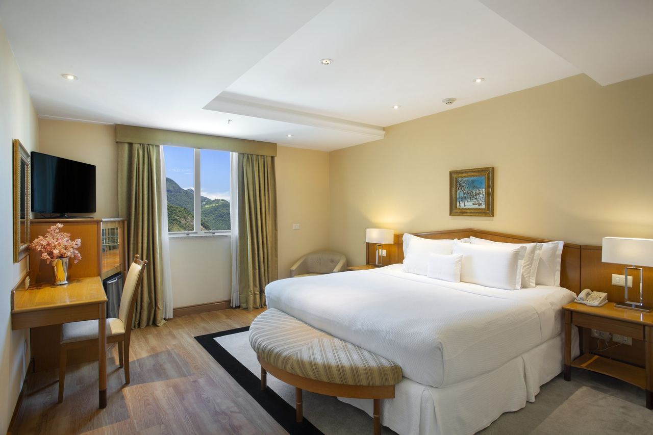 A bedroom at the Windsor Barra, its window looking to the forested hills